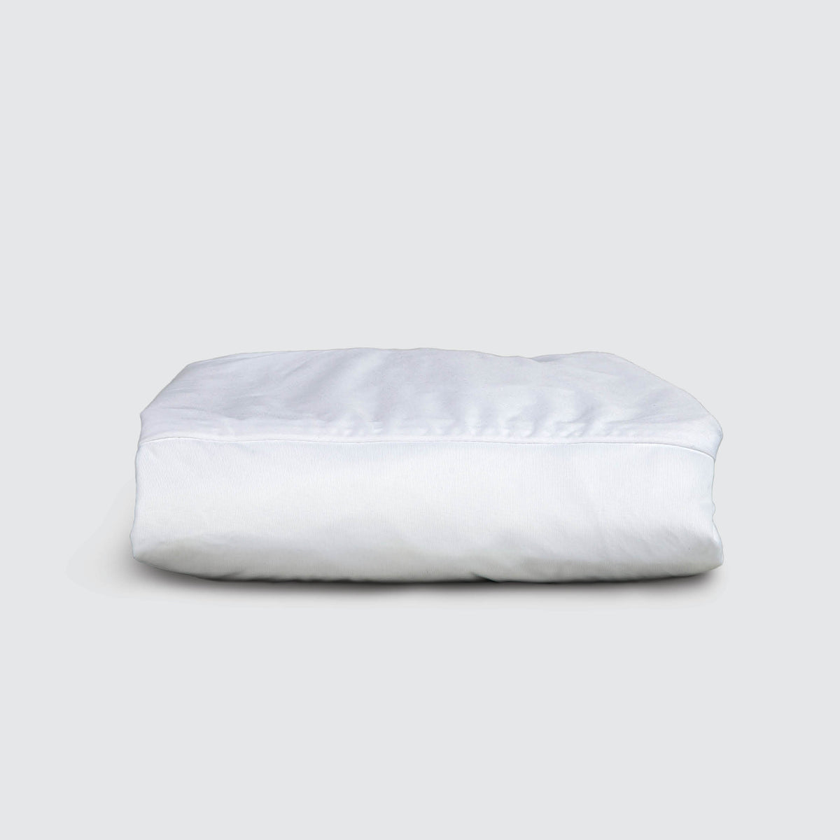 Image of a neatly folded white mattress protector on a white background