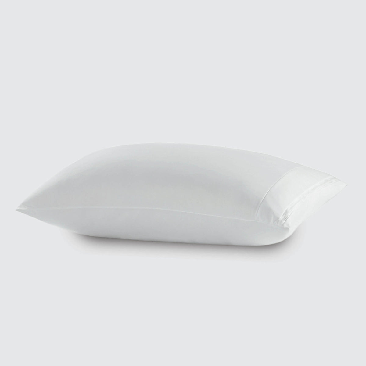 Image of a white pillow protector on a pillow with a white background