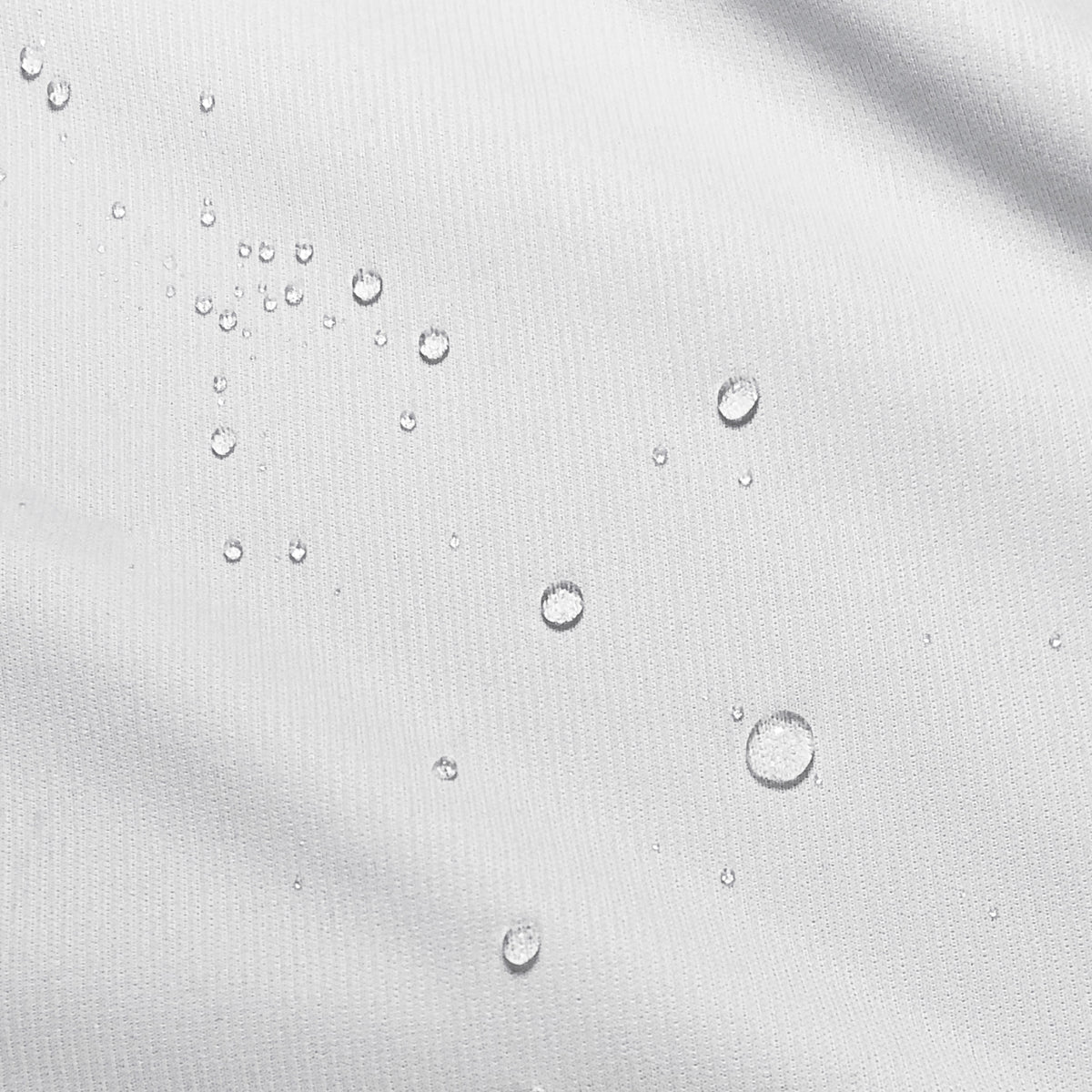 Close-up image of water droplets on a mattress protector