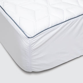Image showcasing the blue piping along the edge of a Cooling Quilted Mattress Protector as well as the elasticized Precision-Fit® corner