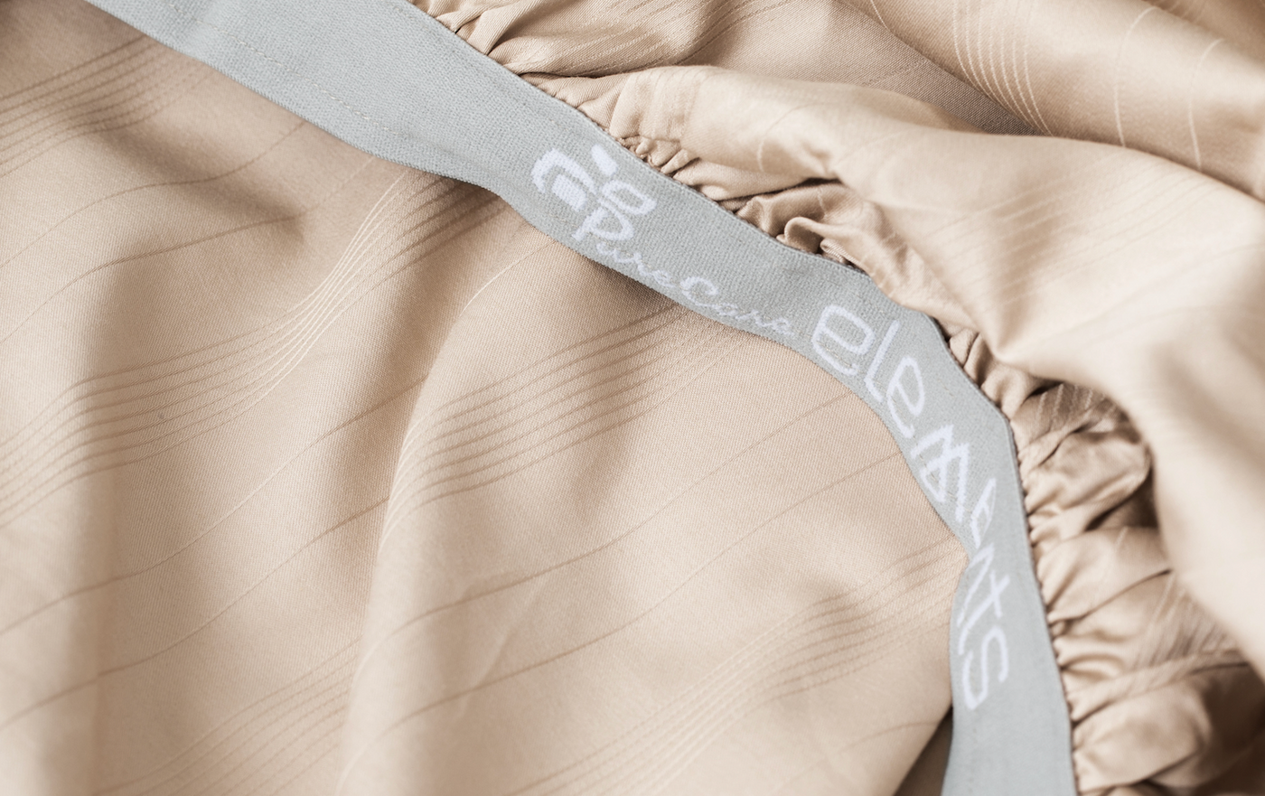 Close-up image showcasing the Precision-Fit® elastic cuff on a Sand Bamboo Rayon fitted sheet