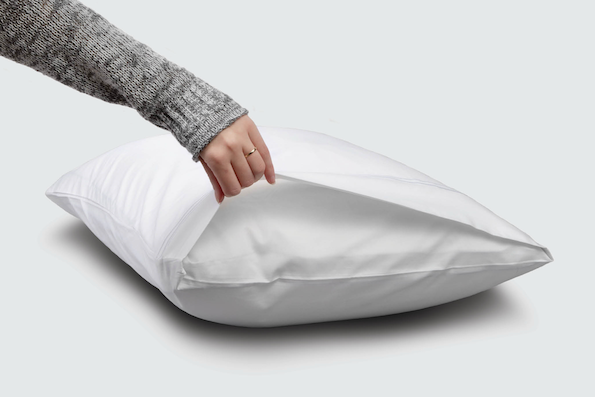 Image of a hand holding open the side of a White Refreshing Pillowcase showcasing the enveloping design