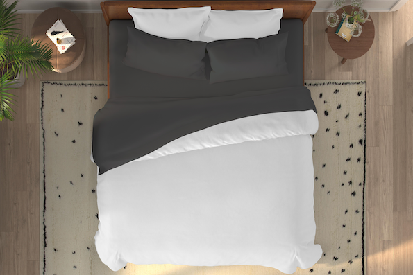Overhead shot of a bed with Shadow Bamboo sheets and pillowcases and a white duvet cover