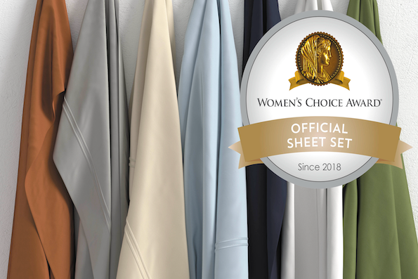 Image of seven hanging Soft Touch sheets of various colors (clay, dove gray, ivory, light blue, midnight, white, moss) with the Women's Choice Award logo in the top right corner
