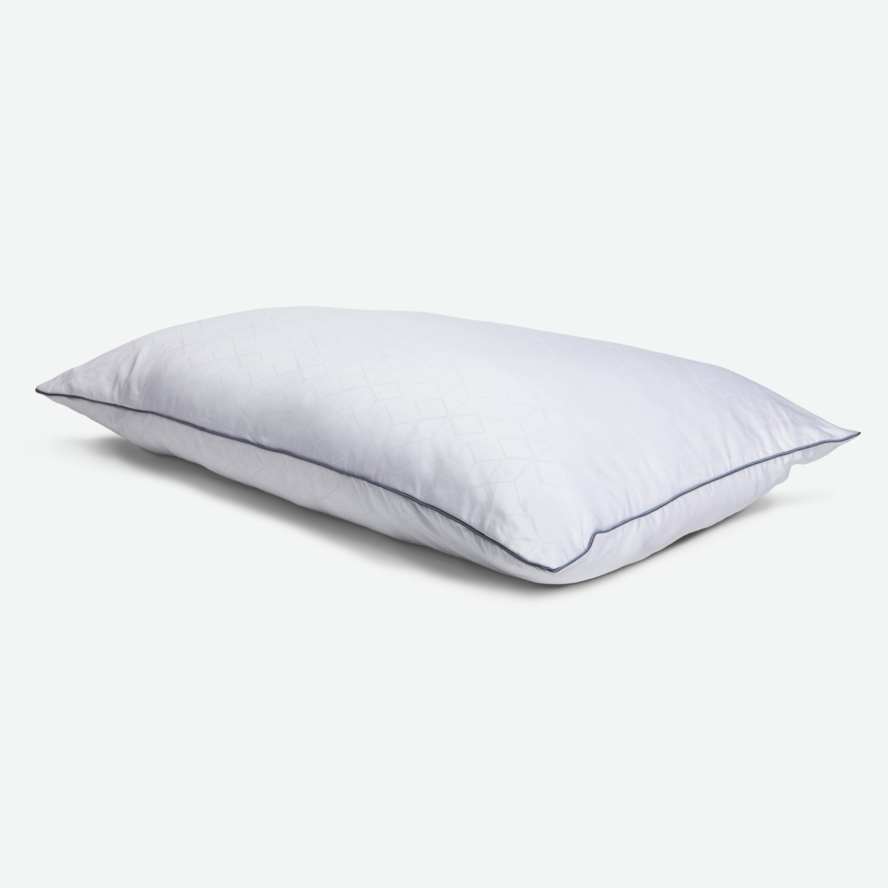 Tabletop image of the Shattered Ice Foam & Fiber Pillow with blue piping 