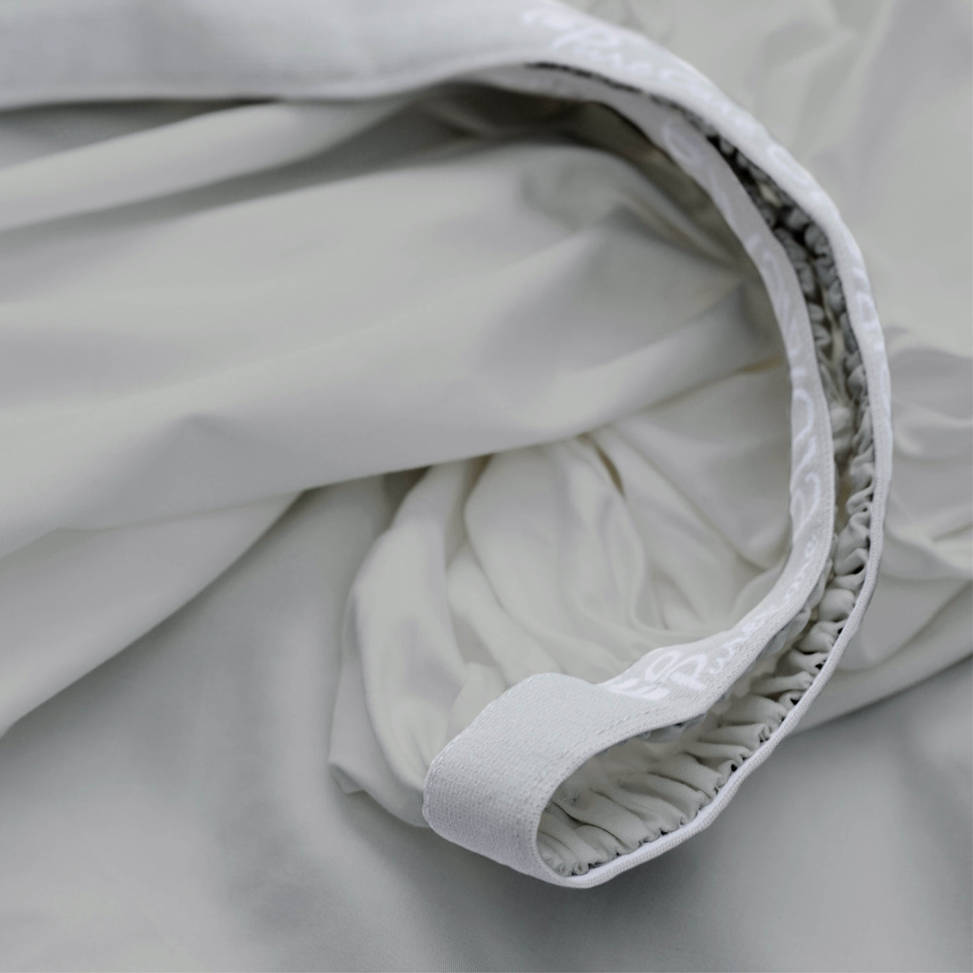 Image showcasing the Precision-Fit® elastic band on the bottom of a Dove Gray Recovery Viscose fitted sheet