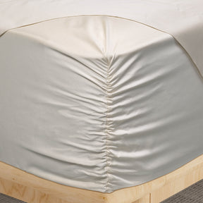 Image of a corner of an Ivory Recovery Viscose fitted sheet showcasing the Precision-Fit® Corner