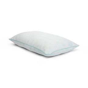 Tabletop image of the Snowflake Foam + Fiber Pillow on a white background. The pillow's cover has a light blue ombre snowflake pattern. 