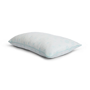 Tabletop image of the Snowflake Foam Pillow on a white background. The pillow's cover has a light blue ombre snowflake pattern. 