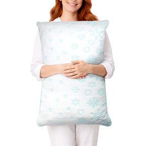 Image of a woman holding a Snowflake Pillow in front of her
