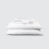 Image of White Soft Touch TENCEL™ Modal Sheet Set stacked top to bottom: Flat Sheet, Fitted Sheet, 2 Pillowcases