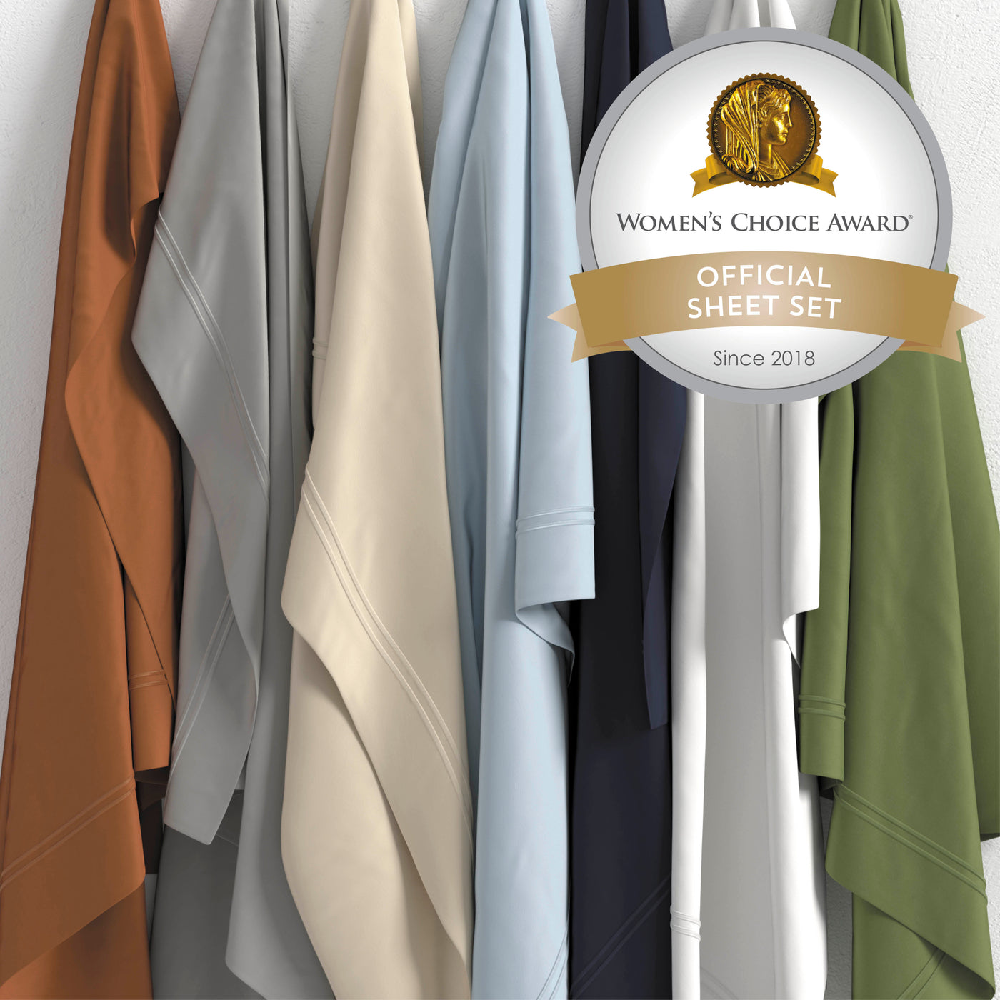 Image of seven hanging sheets of various colors with a sticker in the right top corner reading: Women's Choice Award® Official Sheet Set Since 2018