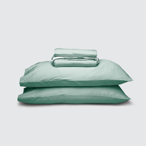 Image of Seafoam Weightless Cotton Sheet Set stacked top to bottom: Flat Sheet, Fitted Sheet, 2 Pillowcases