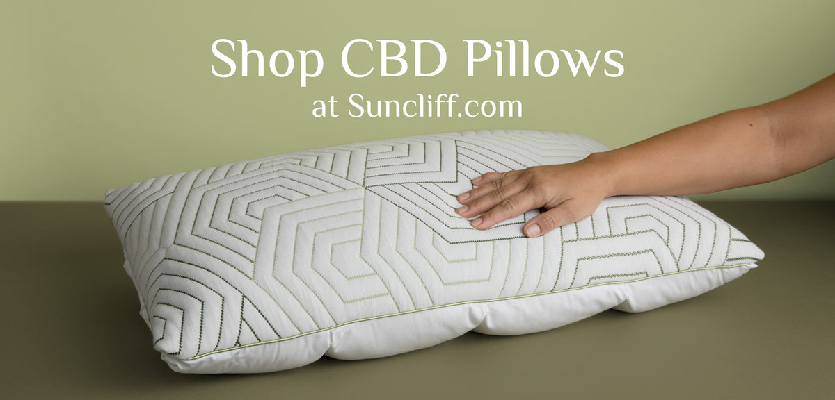 Image of a pillow with sewn-on green hexagon shapes with a green background and the caption: Shop CBD Pillows at Suncliff.com