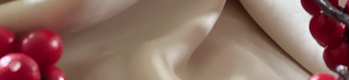 Image of a silky Ivory fabric with cranberries lining each side