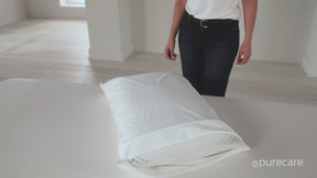 Video of a person zipping a pillow protector onto a pillow. The person then applies weight to the pillow, showcasing the breathable AirXchange® feature. 