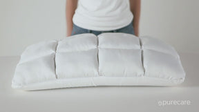 Video of a person squeezing and pressing against both sides of the Cooling SoftCell® Chill Pillow. The person then unzips the pillow and pulls out the adjustable loft insert.