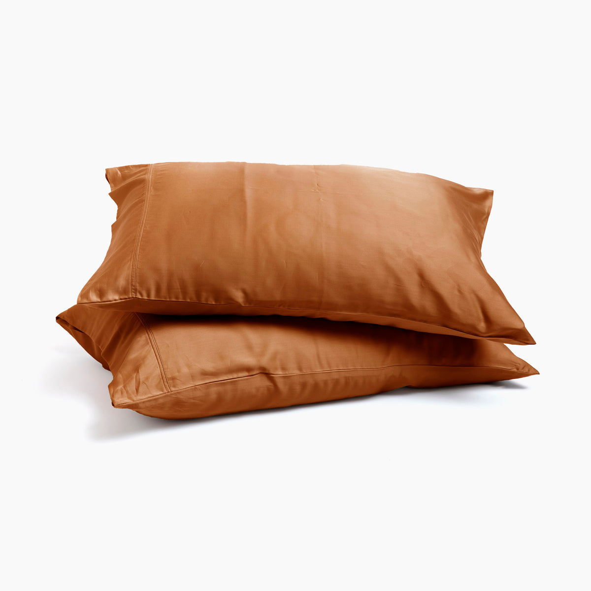 Image of two pillows stacked on top of one another with Clay Recovery Viscose Pillowcases on them with a white background