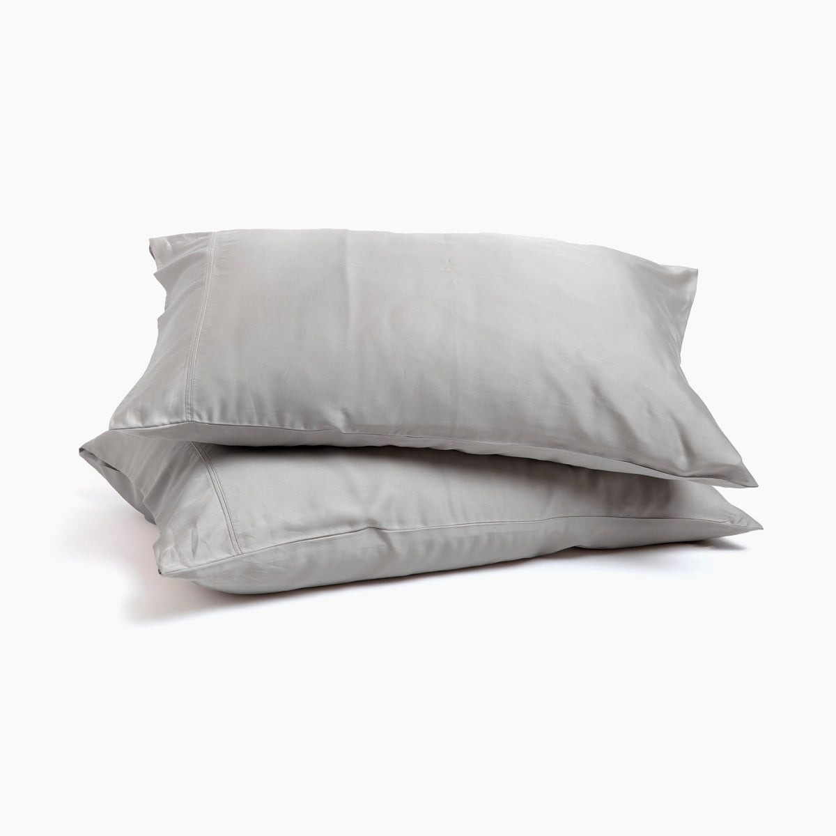 Image of two pillows stacked on top of one another with Dove Gray Recovery Viscose Pillowcases on them with a white background