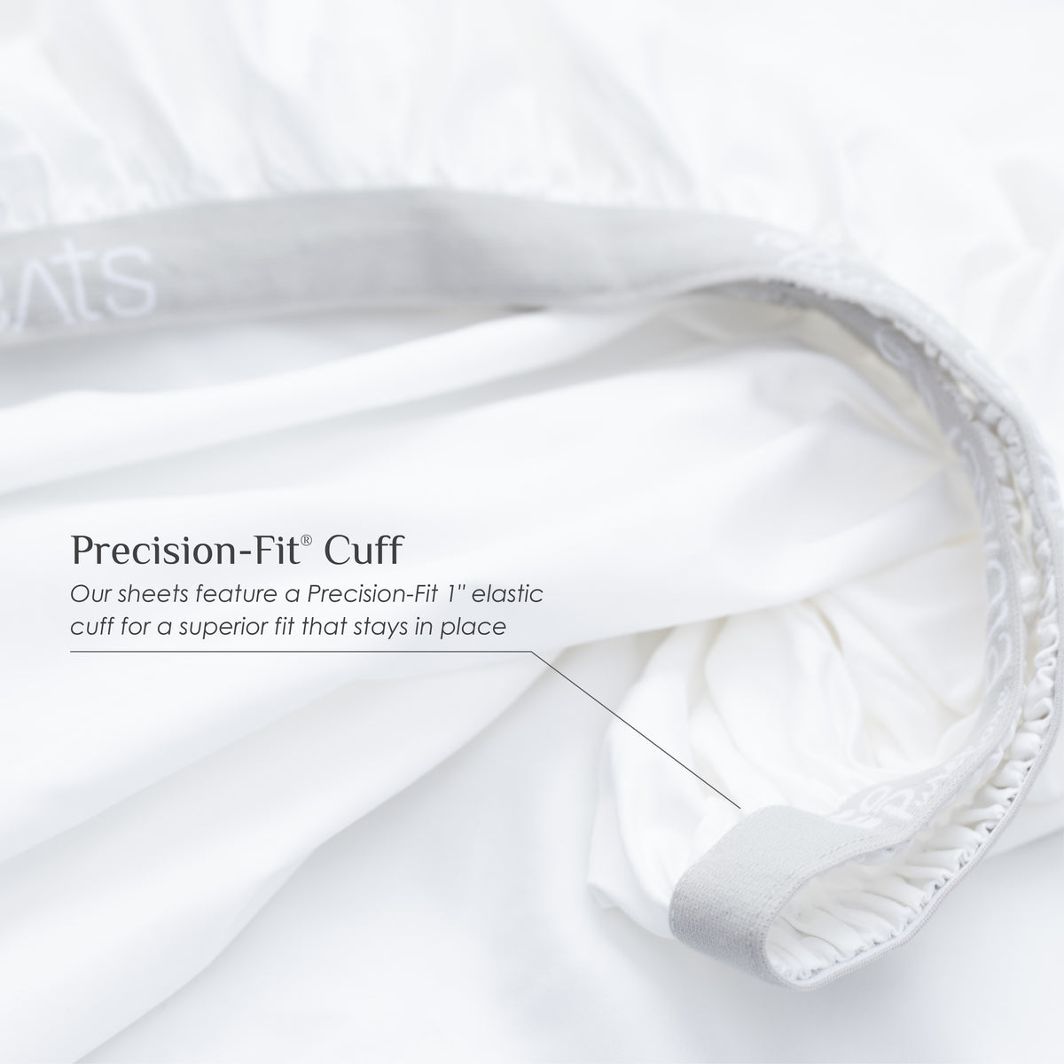 Image of a white fitted sheet showcasing the 1" elastic cuff on the bottom with text over the image reading: "Precision-Fit® Cuff Our sheets feature a Precision-Fit® 1" elastic cuff for a superior fit that stays in place"