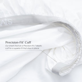 Image of a white fitted sheet showcasing the 1" elastic cuff on the bottom with text over the image reading: "Precision-Fit® Cuff Our sheets feature a Precision-Fit® 1" elastic cuff for a superior fit that stays in place"