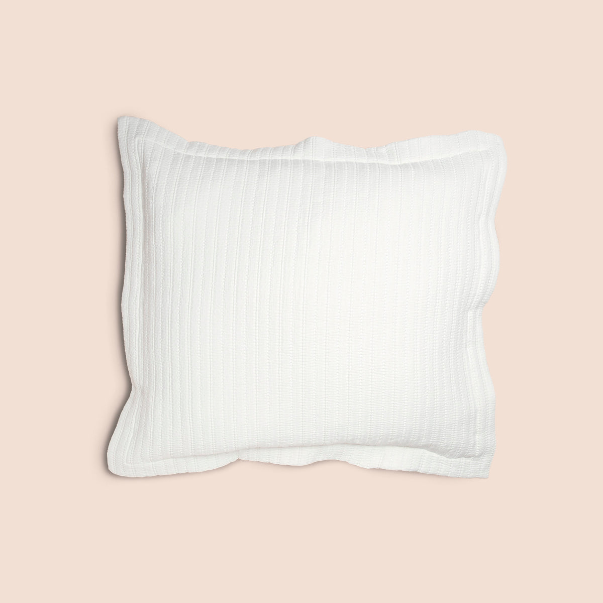 Image of the Ecru Ridgeback Pillow Sham featured on a Euro pillow with a light pink background