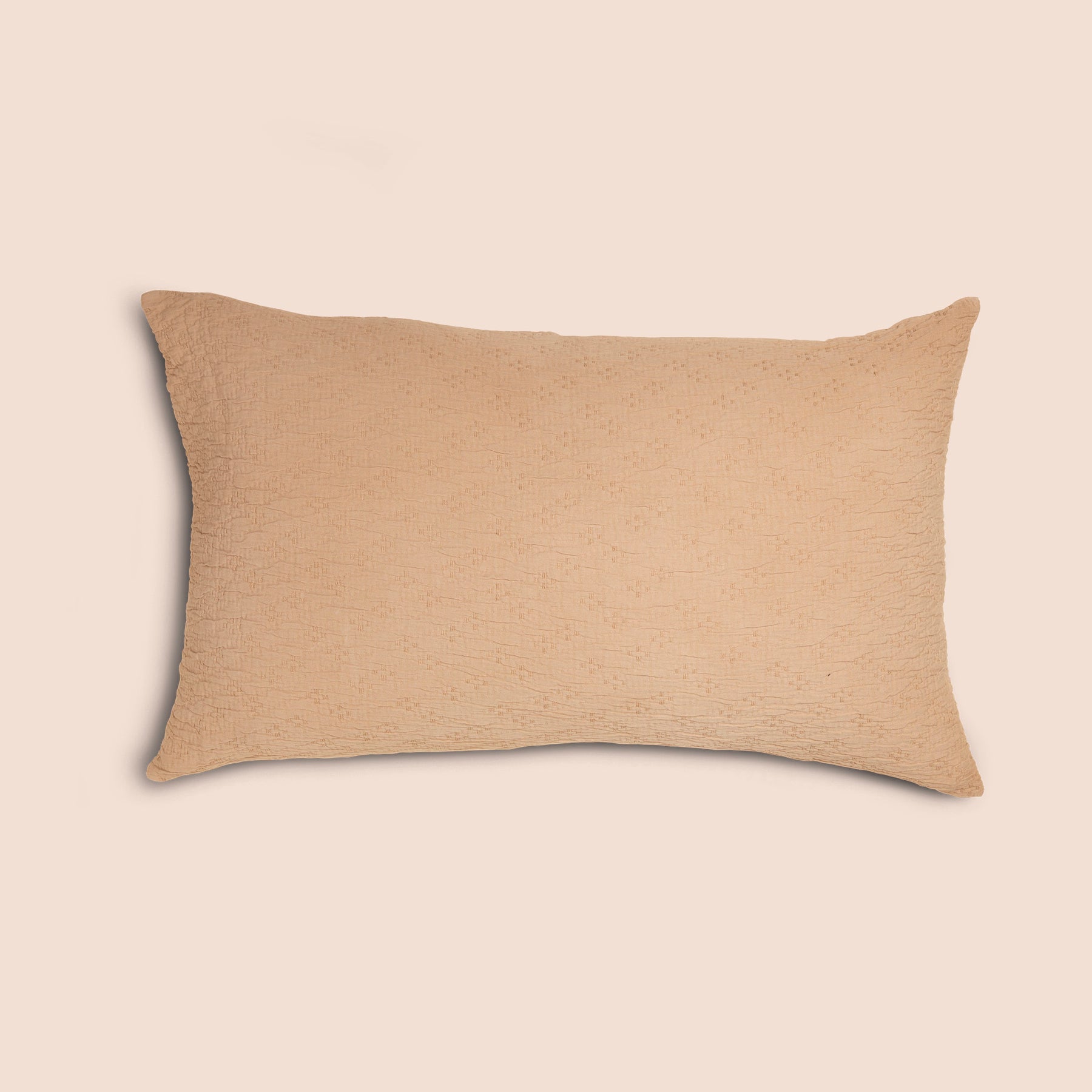 Image of an Ochre Wave Pillow Sham on a pillow with a light pink background