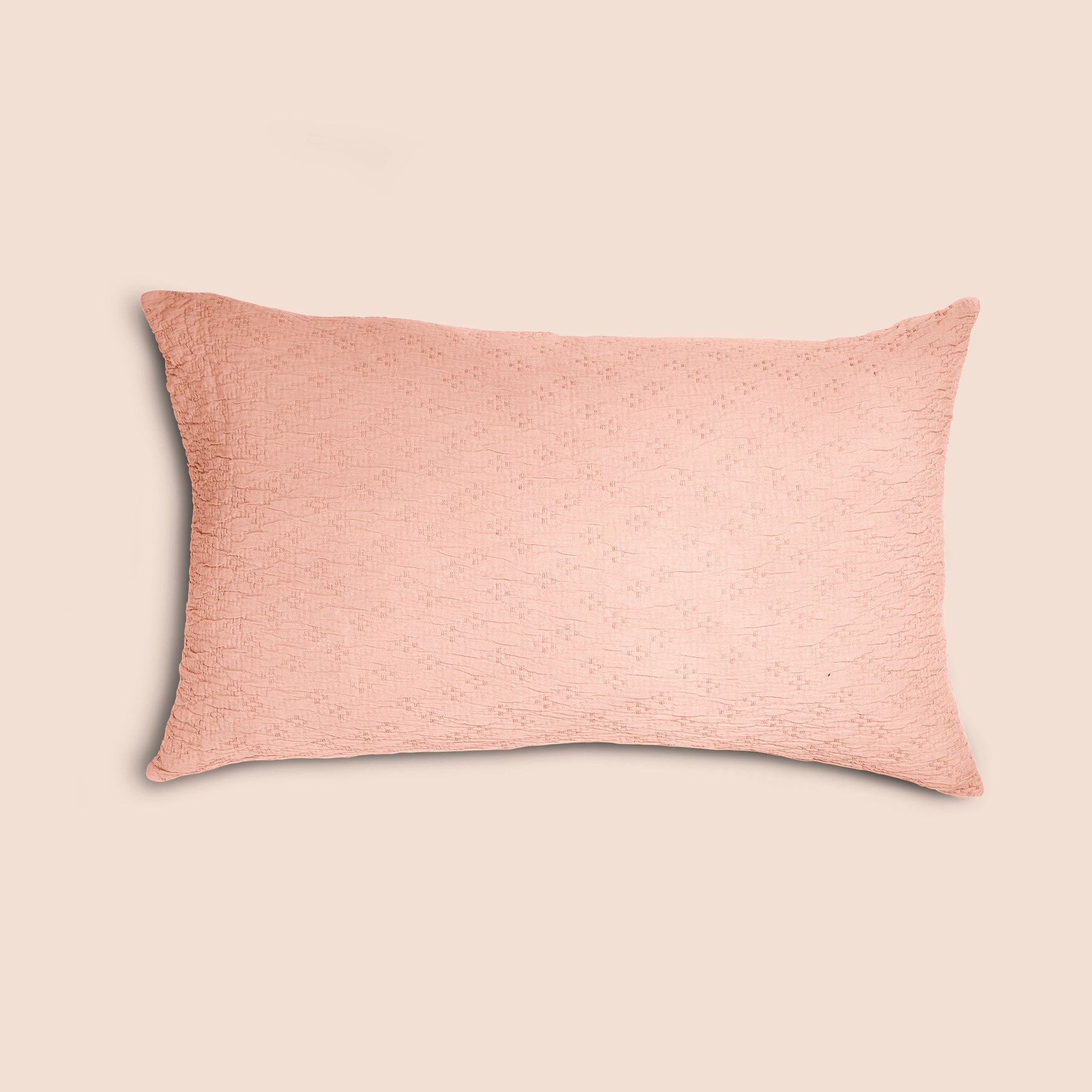 Image of a Pink Sandstone Wave Pillow Sham on a pillow with a light pink background