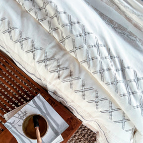 Image of the Sonoran Duvet Cover on a bed with a wooden tray with books and a cup on top