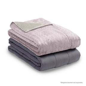 Image of the Soft Pink Weighted Blanket Cover neatly folded on top of a folded Weighted Blanket insert