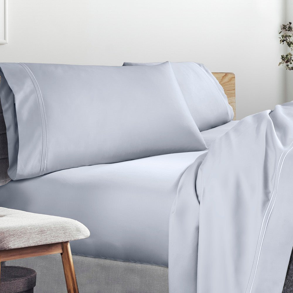 Image of a lived-in bed with a Light Blue Refreshing TENCEL™ Lycocell Sheet Set on it